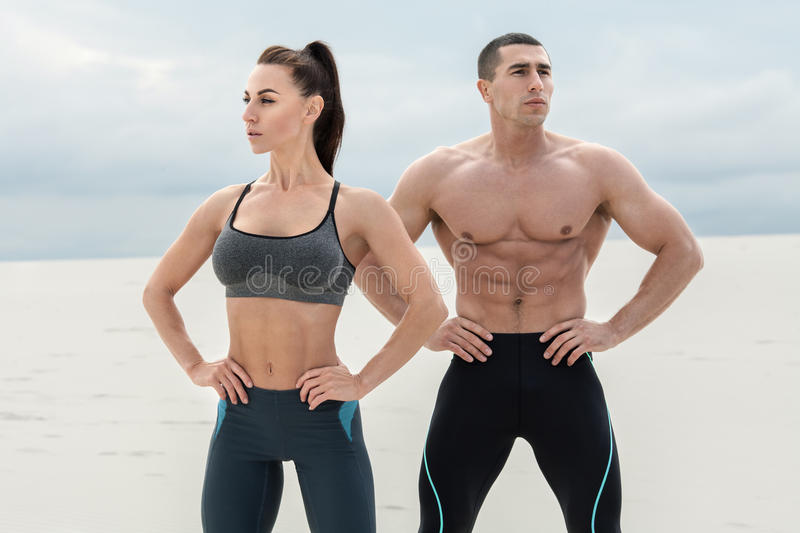 sporty-fitness-couple-showing-muscle-outdoors-beautiful-athletic-man-woman-muscular-torso-abs-men-95263519